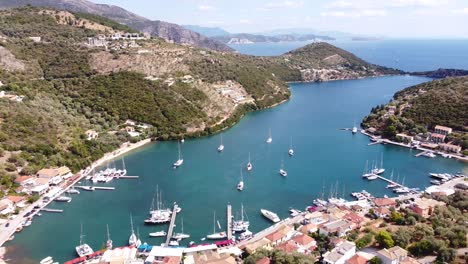 bay of mikros gialos, lefkada ionian island, greece - aerial drone view of the boulevard and harbour with sail boats