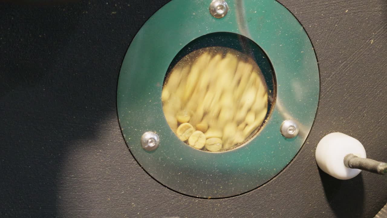 Coffee bean roasting process coffee shop industrial setting close-up craftsmanship