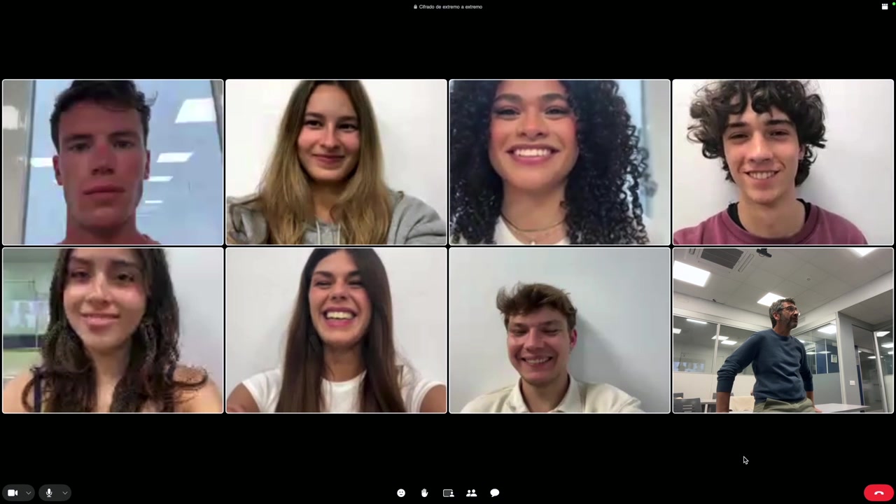 Diverse Group of People Waving and Smiling in an Online Video Call