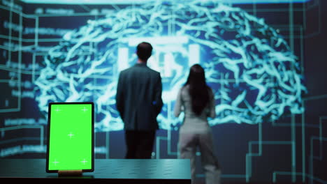 engineers use green screen tablet and ai neural networks to look at data