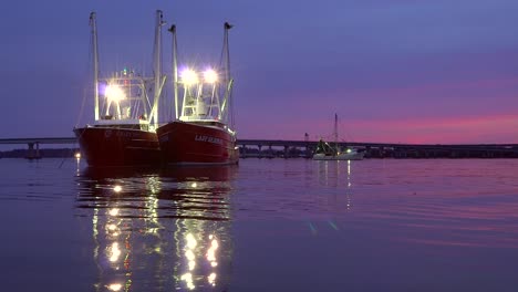 two shrimp trawlers, commercial fishing boats docked in new bern during a protest against regulations, at dusk, in north carolina