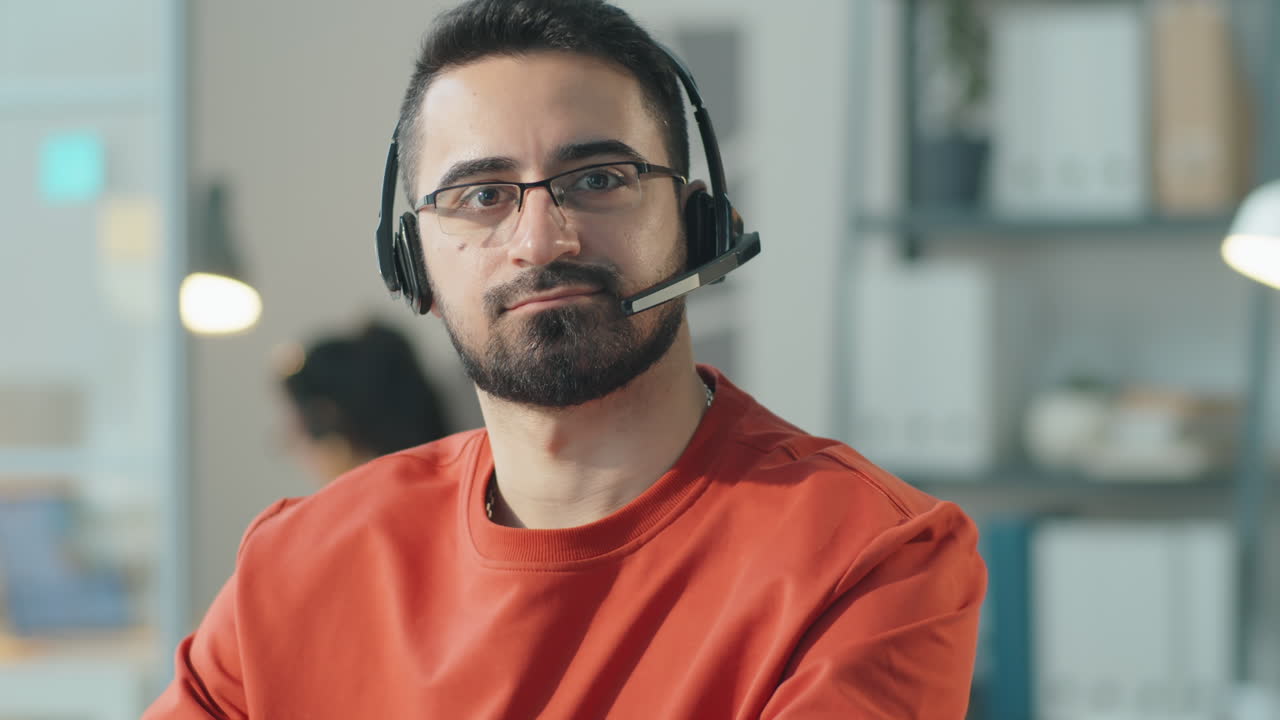 Portrait of Man in Headset at Work in Call Center
