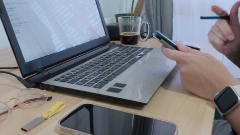 student using a tablet for e-books or notes alongside a laptop for research or assignments