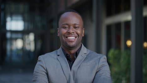 portrait young successful black businessman smiling arms crossed enjoying professional urban lifestyle in city ambitious african american entrepreneur looking confident