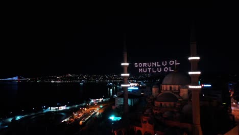 aerial night view of new mosque. there says " be responsible, be happy"