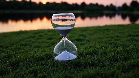 hourglass at sunset by the lake