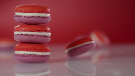 a macaroon is spinning on a surface near a stack of macaroons