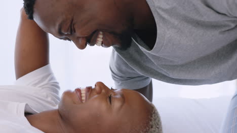 Love,-kissing-and-smile-bedroom-couple-relaxing