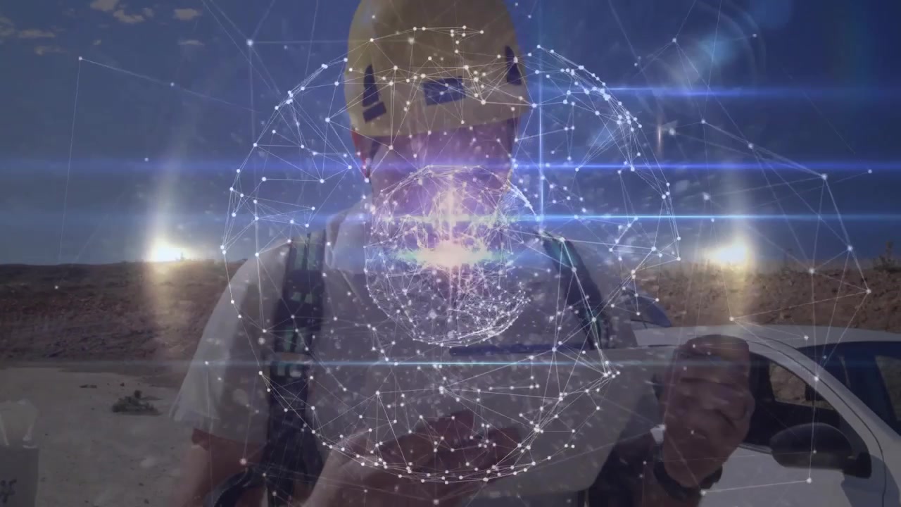 Tekniker tapper på håndholdt enhed på vind- og solcelleanlæg, der overvåger elnettet, med en 3D-sfære, der udvider sig.