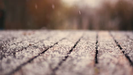 close up of snow falling on a table outside