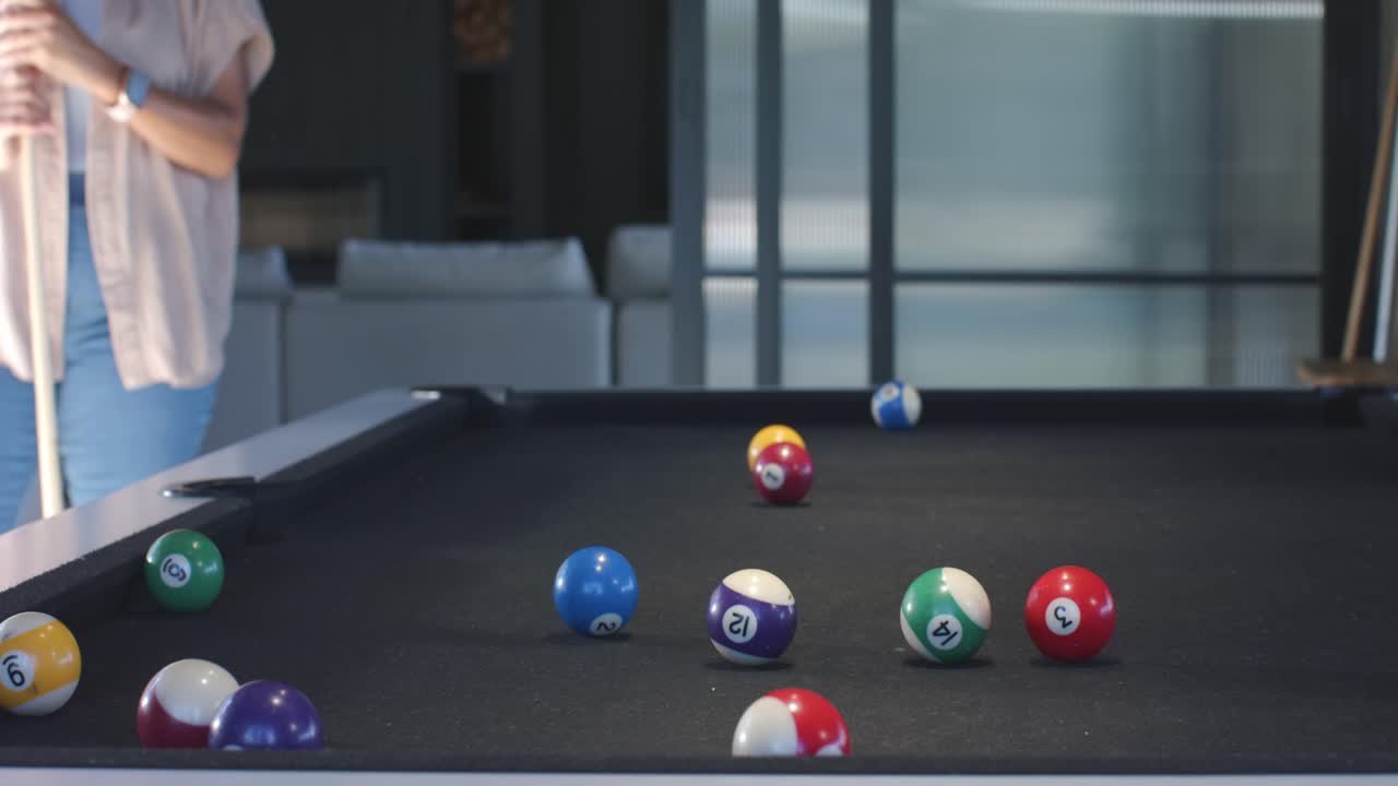 Cue ball drifting to pocket woman moving pool-table home adjusting cue readying, copy space