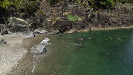 Coastal-Waters-with-Waves-Along-a-Beach-and-Rocks-at-Secret-Cove,-Sandpit,-Canada