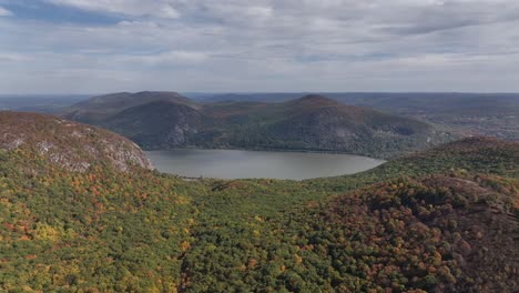 an aerial view high above the mountains in upstate ny during the fall foliage changes on a beautiful day