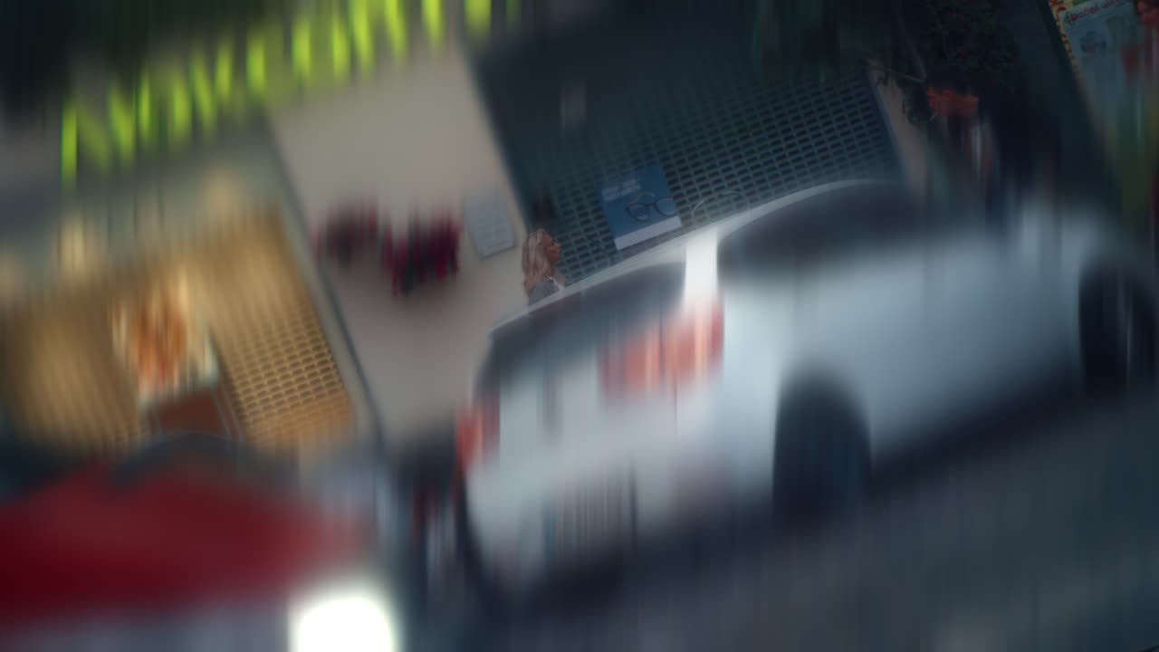 Blurred background girl going forward in city evening road with passing cars.