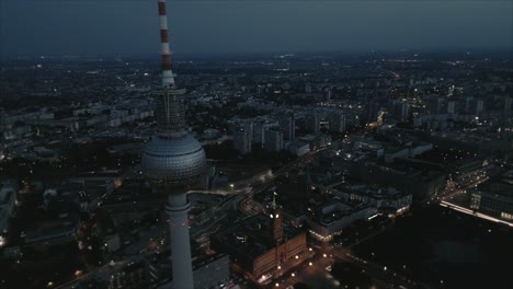 Wide-aerial-shot-of-Berlin-TV-Tower-and-town-hall-at-dusk-night