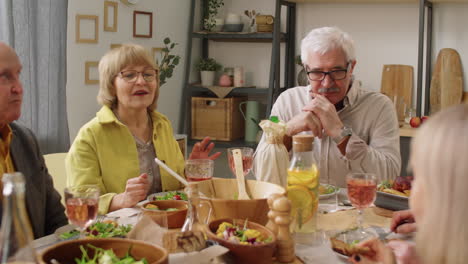 Senior-Couple-Talking-with-Guests-on-Dinner