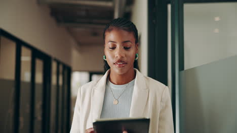 a businesswoman working on a tablet in an office