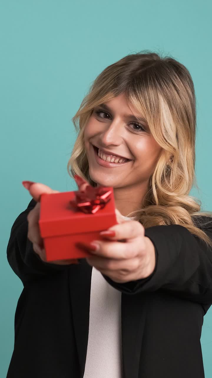 Happy transgender businesswoman offering small gift box