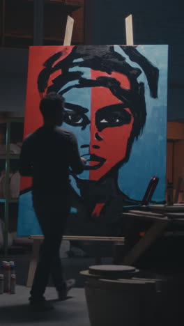 artist painting a portrait in a studio