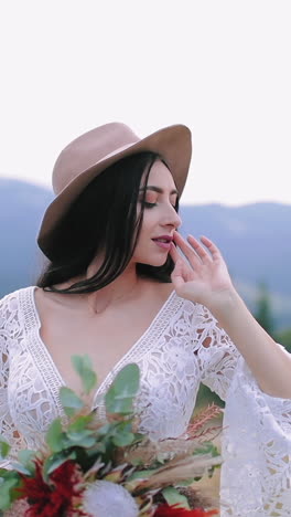 stylish bride on mountain. young bride waking on the hill in the mountains with beautiful landscape