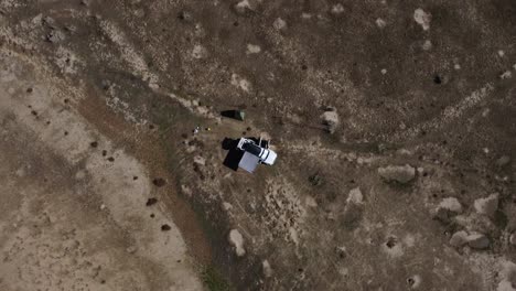Top-down-view-of-couple-car-camping-in-a-Subaru-Forester-in-Fruita-Colorado,-Aerial