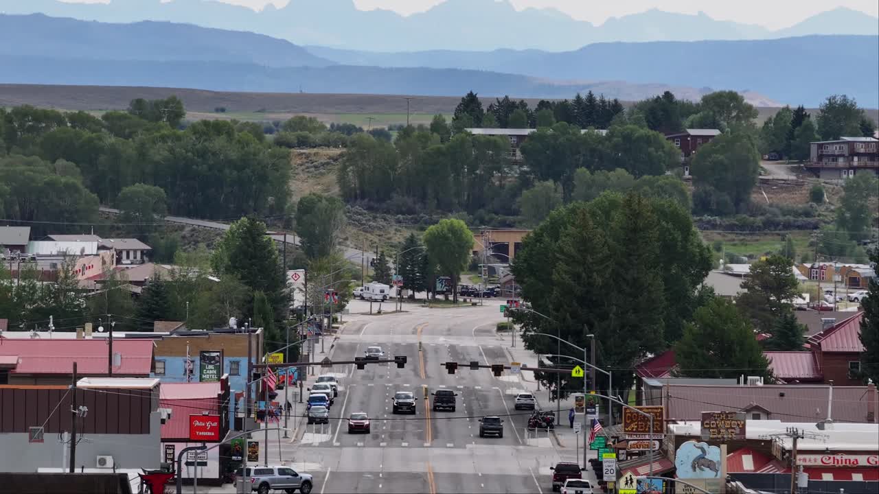 A scenic town view of Pinedale, Wyoming with distant mountains and lush greenery