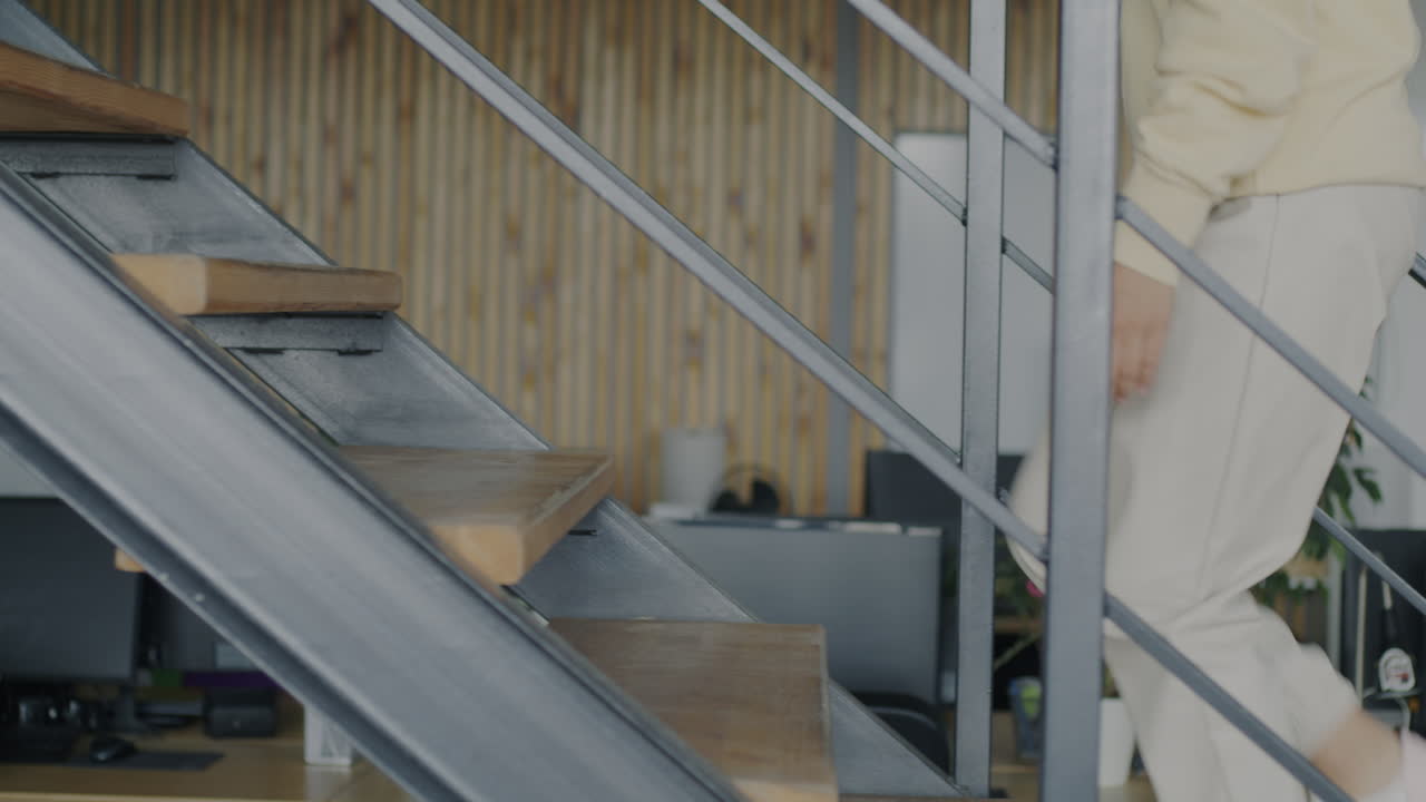 Woman walking up the stairs in a modern office