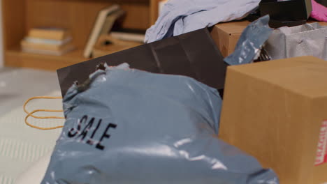 pile of shopping bags, boxes, and clothing