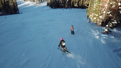 aerial - people skiing down a mountain in lake tahoe, wide shot forward