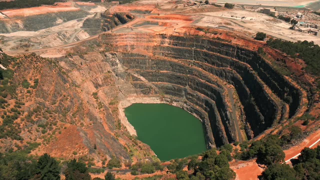 drone shot revealing an abandoned mine pit and a mining site in the background in western Australia
