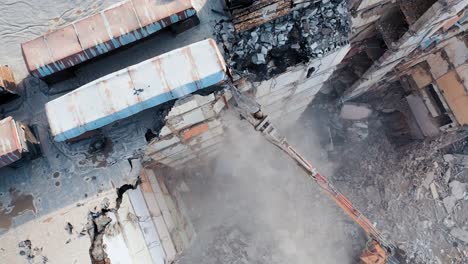 dismantling of concrete structures with an excavator. demolition of a multi-story building, for future development of residential buildings