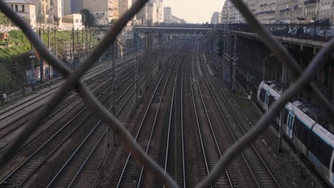 subway train arriving at the terminal station in paris filmed behind a fence