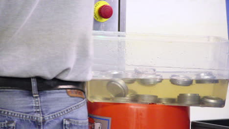 close up of cleaning process of can lid for beer in beer factory