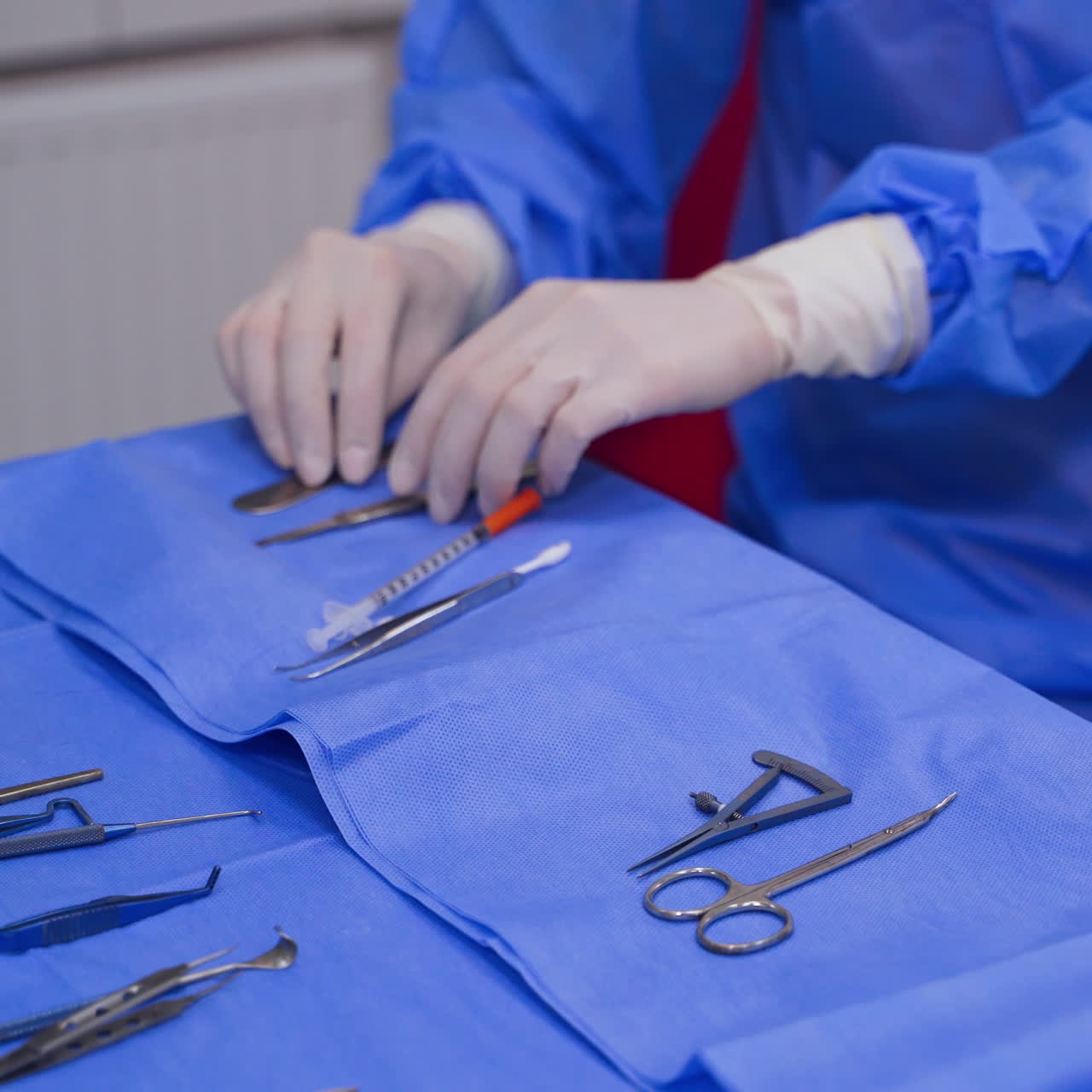 Medical instruments on the table. Doctor's hands taking necessary instruments during operation. Close-up.