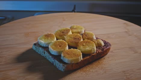 wholemeal toast with blueberry jam, peanut butter, ripe banana slices, and cinnamon powder