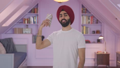 sikh indian man using money as fan in attitude