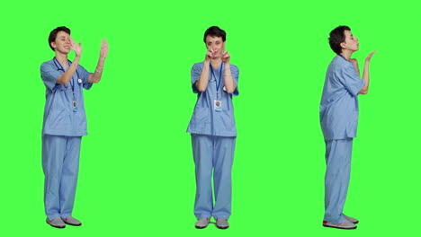 Flirty-cute-nurse-blowing-air-kisses-against-greenscreen-backdrop