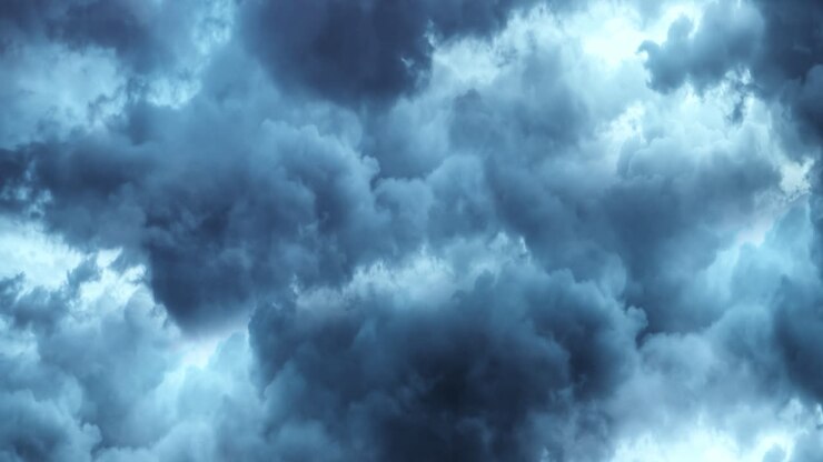 thick and dark clouds in the sky with flashes of lightning in them