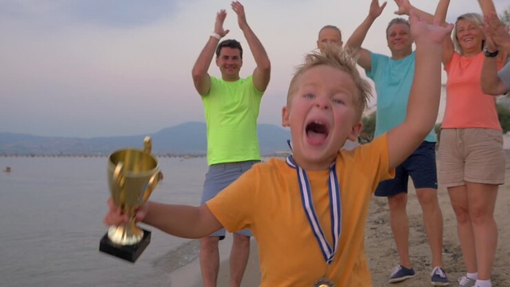 Happy little winner running with trophy