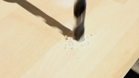 close up of a bit drilling a hole