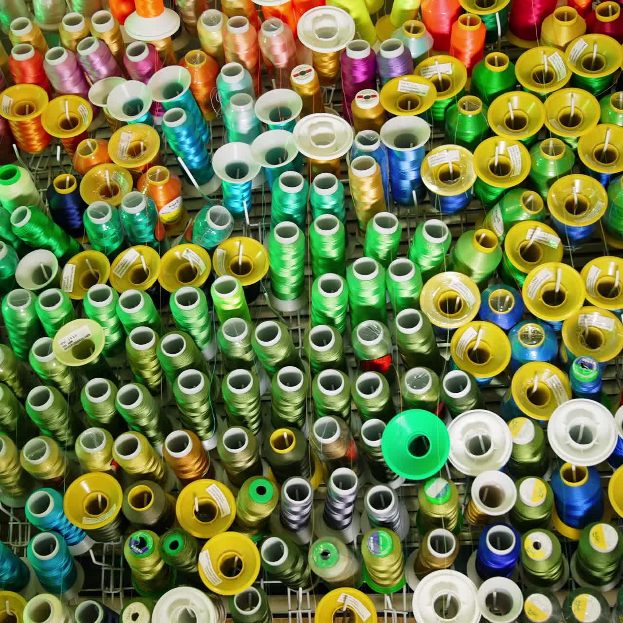 Colorful sewing tools on a wall. Rolls of threads hanging on a wall