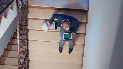 top view of manager comparing information from tablet overtime