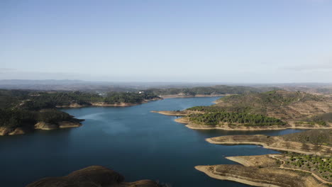 drone flight over santa clara lake in the algarve region showing the mountains and the special geography of this region