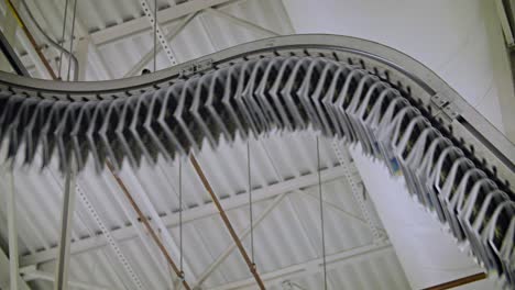 newspapers move along an overhead conveyor belt at a newspaper factory 4