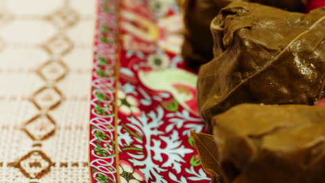 close-up of stuffed grape leaves (dolma) on a decorated plate