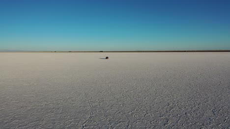 car drives through salt flats