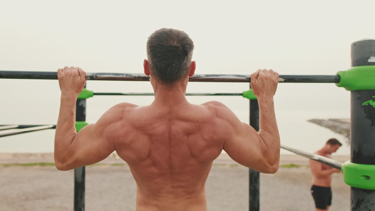 Man doing pull-ups outdoors