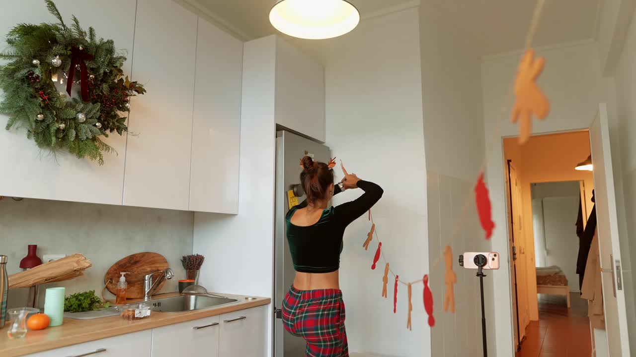Woman Decorating Kitchen for Christmas