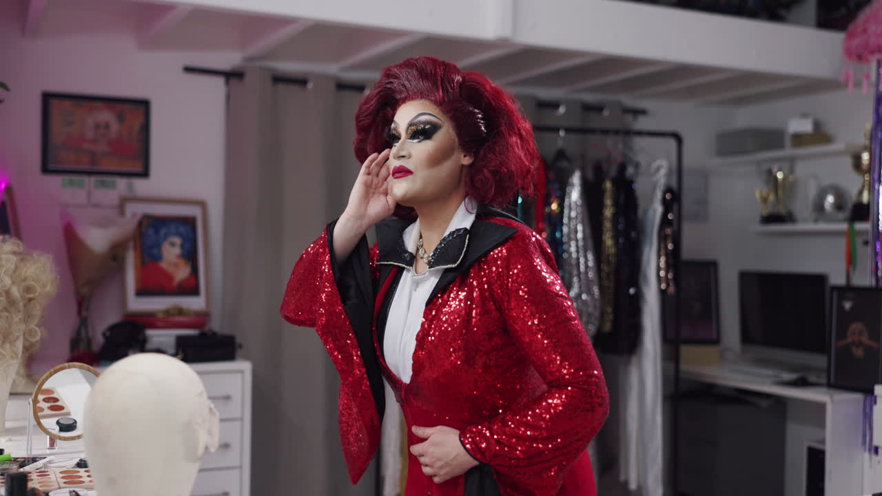A drag queen in a red sequin jacket