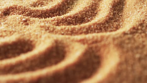 Video-of-close-up-of-sand-grains-with-pattern-and-copy-space-background